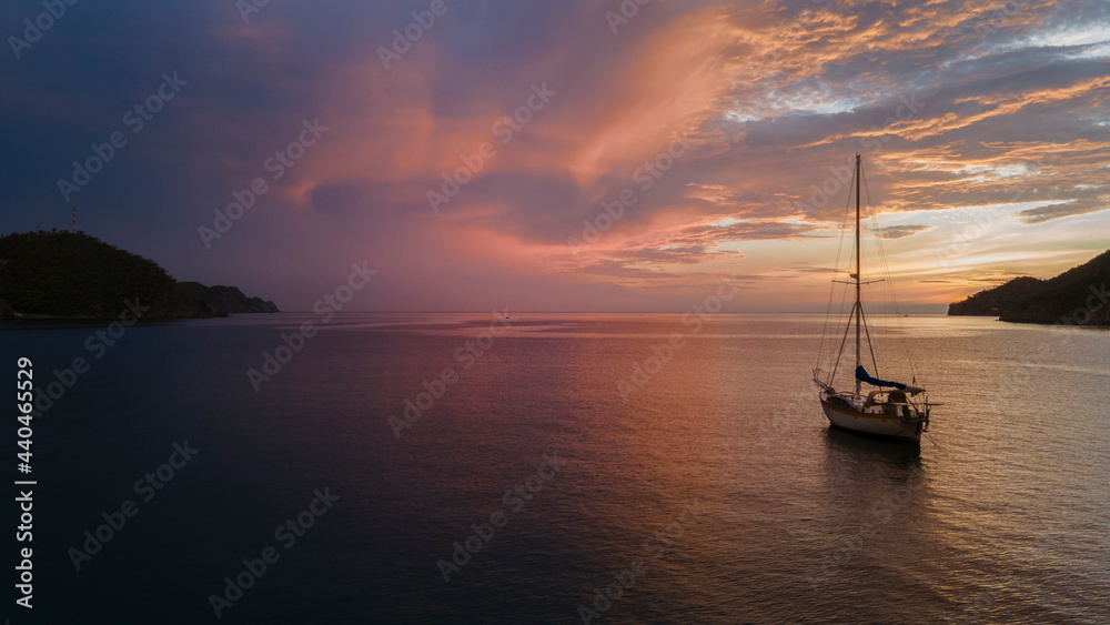 Panoramic ocean view with sailboat at sunset Colombia