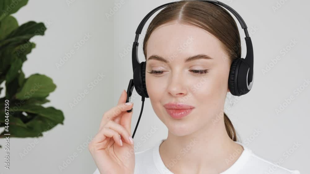 Woman call center operator in headphones microphone face close up customer support female Woman call center operator in headphones microphone face close up customer support female