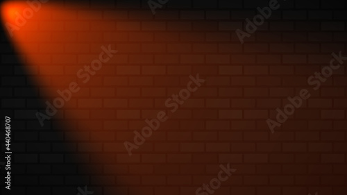 Empty brick wall with orange neon spotlight with copy space. Lighting effect orange color glow on brick wall background. Royalty high-quality free stock photo of lights blank background for texture
