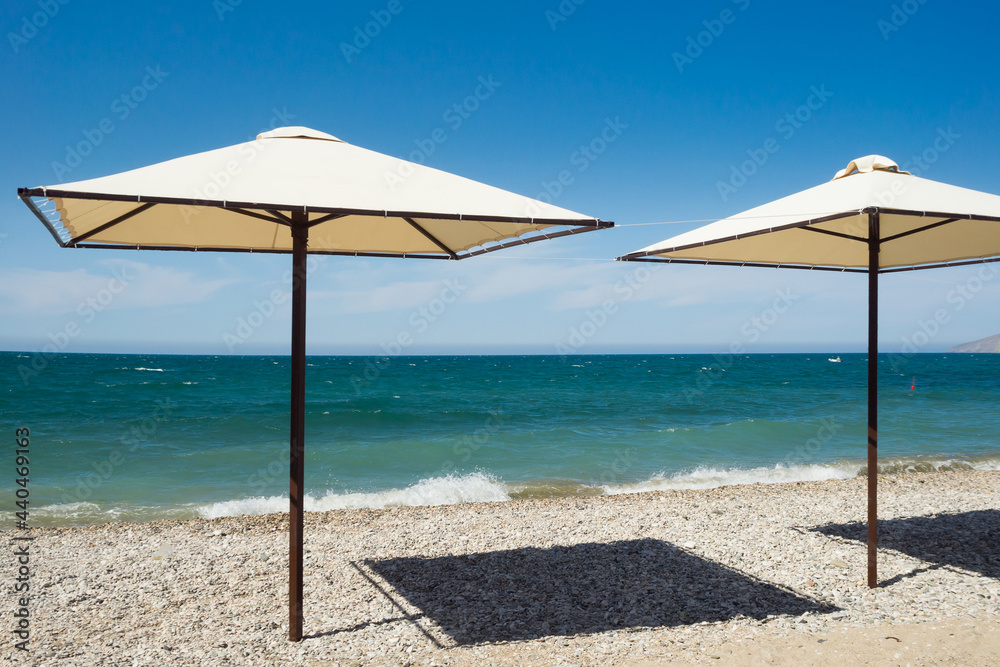 Fototapeta premium Beach umbrella on the Black Sea coast. Swimming season.