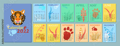 Vertical calendar for the year 2022 with the head of a tiger. Colored background, plants and tiger footprints in abstract style. Week starts in Sunday. Template in size A4