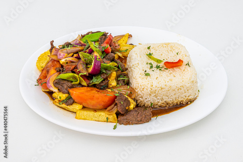 Tray of beef tenderloin sautéed with peppers, tomato, onion, chives and parsley cooked with Peruvian recipe with white rice, french fries and vegetables sauteed with soy sauce