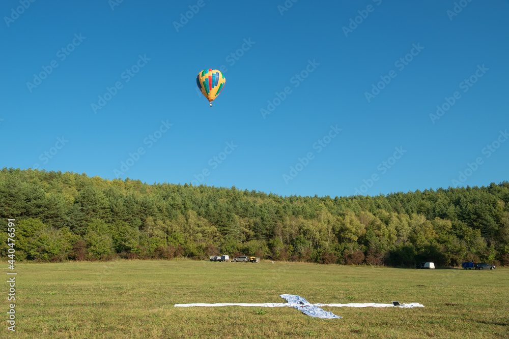 Obraz premium Multicoloured hot air balloon in the sky on a beautiful summer morning on the Balloon festival.