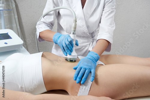 Hardware cosmetology. Young woman getting beauty treatment in spa salon photo