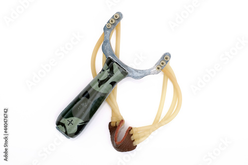 Steel, sport fishing slingshot with triple harness. Hunting slingshot on a white background. Slingshot made of metal with elastic bands.