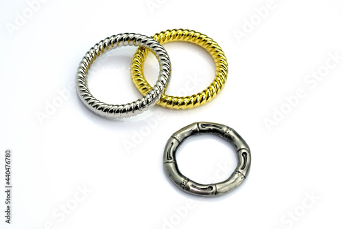 Decorative rings connecting with braiding. Metal ring for clothes on a white background. Cast ring for sewing production.