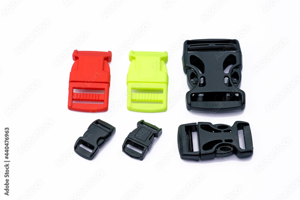 Plastic belt clips, length adjusters for plastic bags, different colors. Plastic fastexes on a bag strap, on a backpack strap on a white background. Plastic belt clips, length adjusters for plastic bags, different colors. Plastic fastexes on a bag strap, on a backpack strap on a white background.