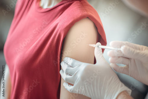 A woman getting vaccinated, coronavirus, covid-19 and vaccination concept.