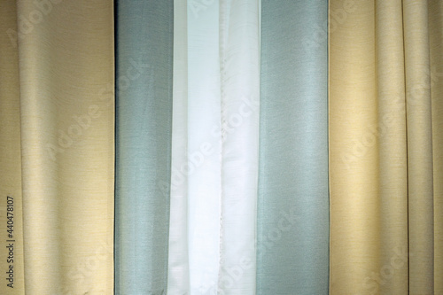 Three-layer curtains in yellow, green fabric and white tulle.