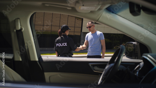 Male driver taking documents from police officer © Framestock