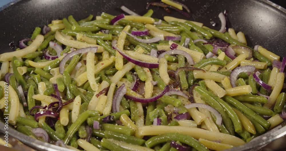 Spices are added to the asparagus in a frying pan. Cooking. Spices are added to the asparagus in a frying pan. Cooking.