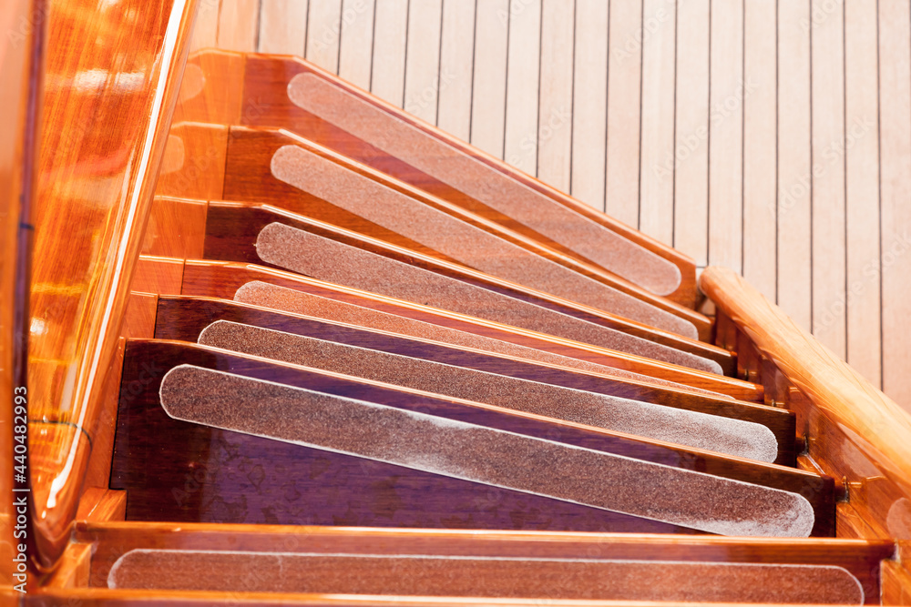 Spiral wooden steps on a luxury yacht. Luxury yacht interior in wooden style.