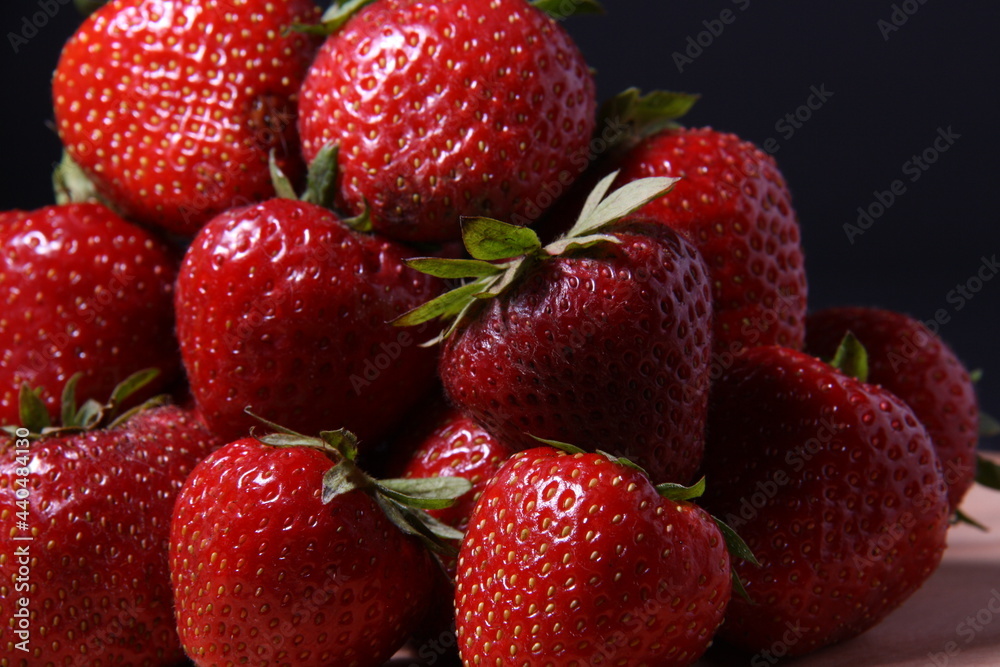 horizontally oriented image, close-up of a small pile of berries, ripe fresh strawberries horizontally oriented image, close-up of a small pile of berries, ripe fresh strawberries