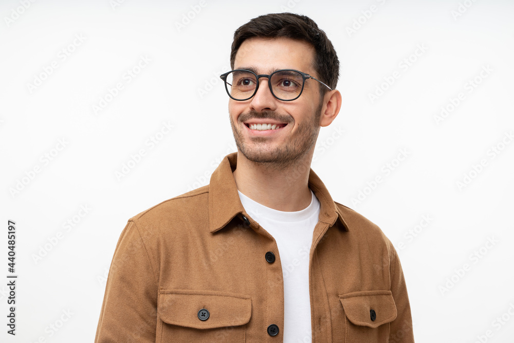 Portrait of handsome man wearing glasses, looking away as if thinking of future, isolated on gray background. Eyewear fashion ads Portrait of handsome man wearing glasses, looking away as if thinking of future, isolated on gray background. Eyewear fashion ads