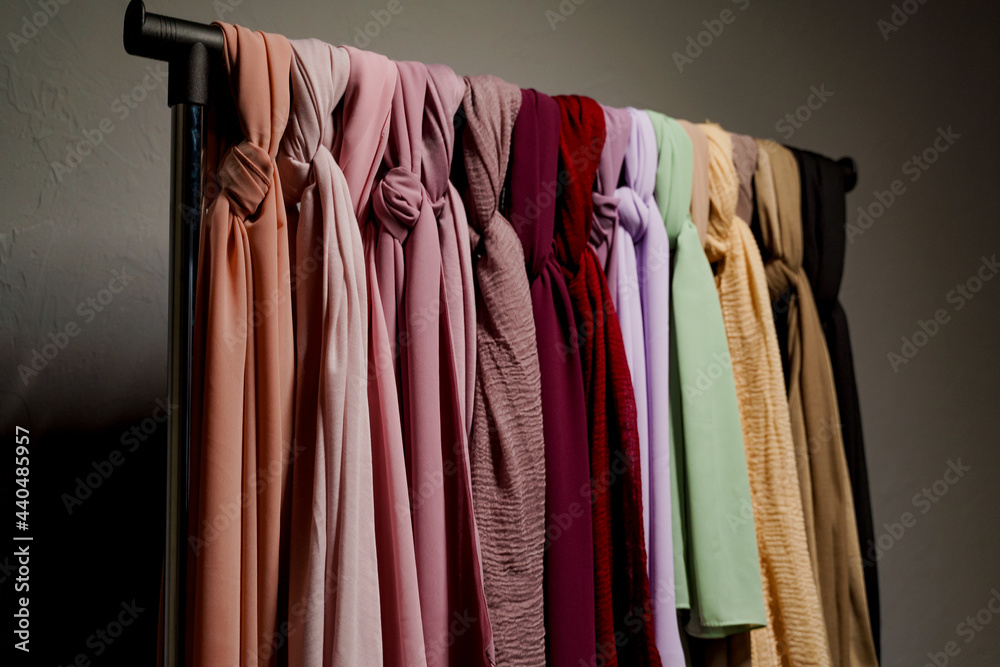 Obraz premium Silk scarf muslim. Multi-colored plain scarves on hanger.