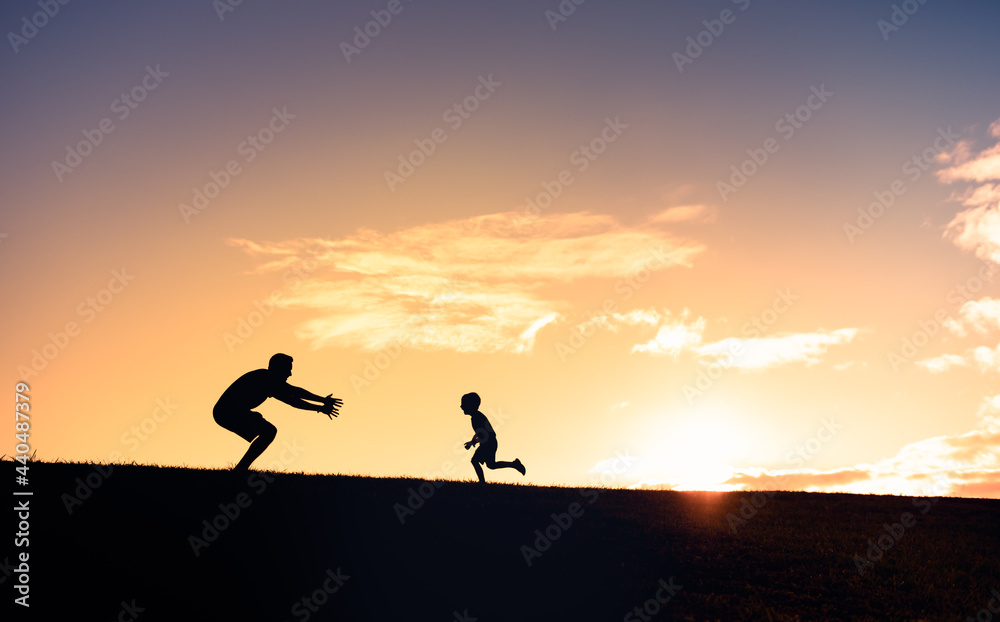 Little boy running to give his father a hug. Father son relationships. 