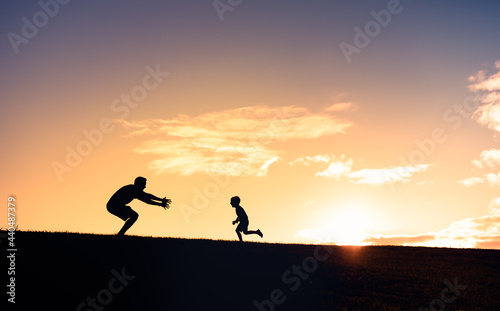 Little boy running to give his father a hug. Father son relationships. 