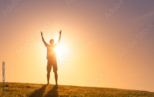 Young man hands up to the sky. Happiness and worship concept. 