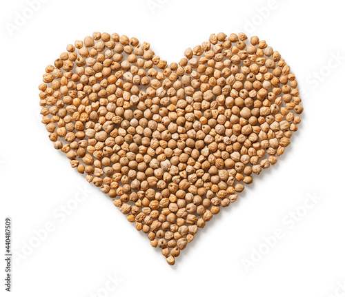 Raw dry chickpeas in a heart shape isolated on white background. Vegetarian food and hummus ingredient. Legume as source of vegetable protein, carbohydrates, fats and fiber.