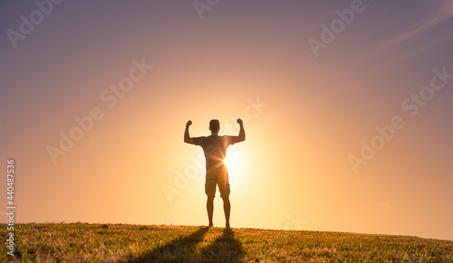 Man power! Strong male flexing his arms up to the sky. Strength and determination concept. 