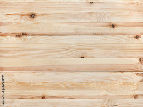 Texture of new wooden planks with brown knots. Background of horizontal pine timber boards of natural color. Smooth surface of wood rustic table top. Full frame design element.