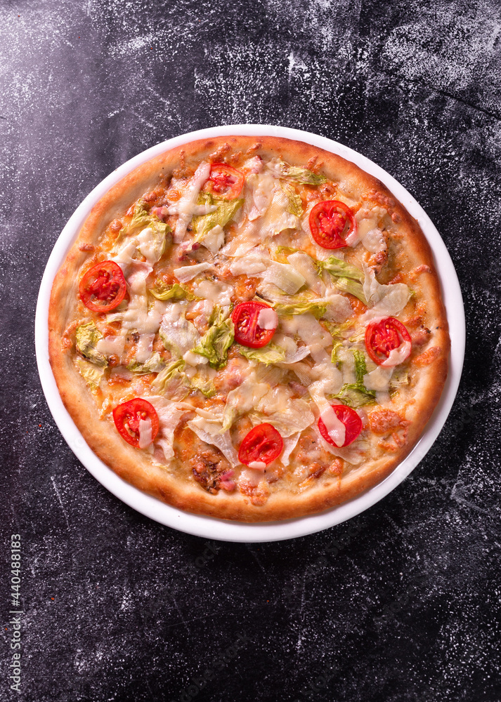 Chicken pizza with cherry tomatoes and fresh chinese cabbage on marble background