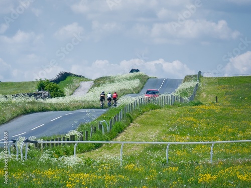 A group of cyclists ride through the Yorkshire Dales near Middleham Gallops in Wensleydale, North Yorkshire. photo