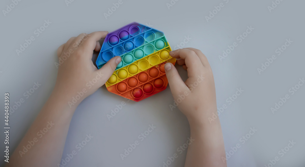 Obraz premium the child's hands are holding an antistress toy 