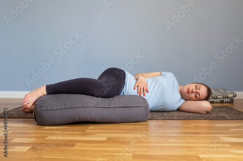 Pregnant woman lying in Shavasana, resting after practice, meditating