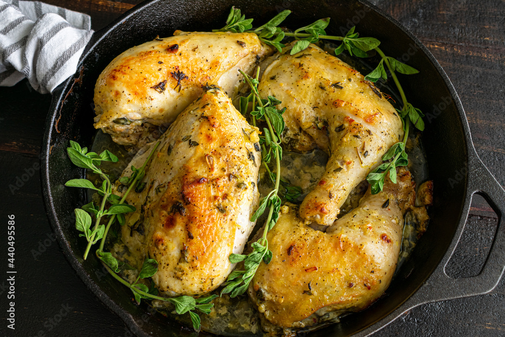 OvenRoasted Greek Chicken Quarters in a CastIron Skillet Pieces of