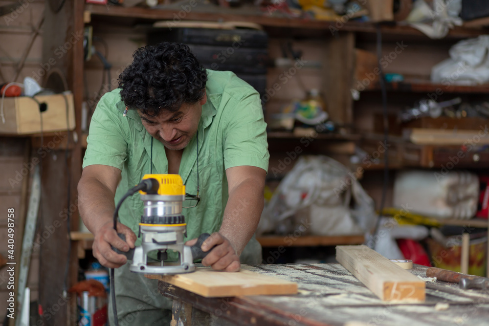 Mexican woodworker, carpenter working in his workshop Mexican woodworker, carpenter working in his workshop