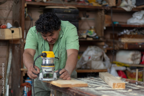 Mexican woodworker, carpenter working in his workshop