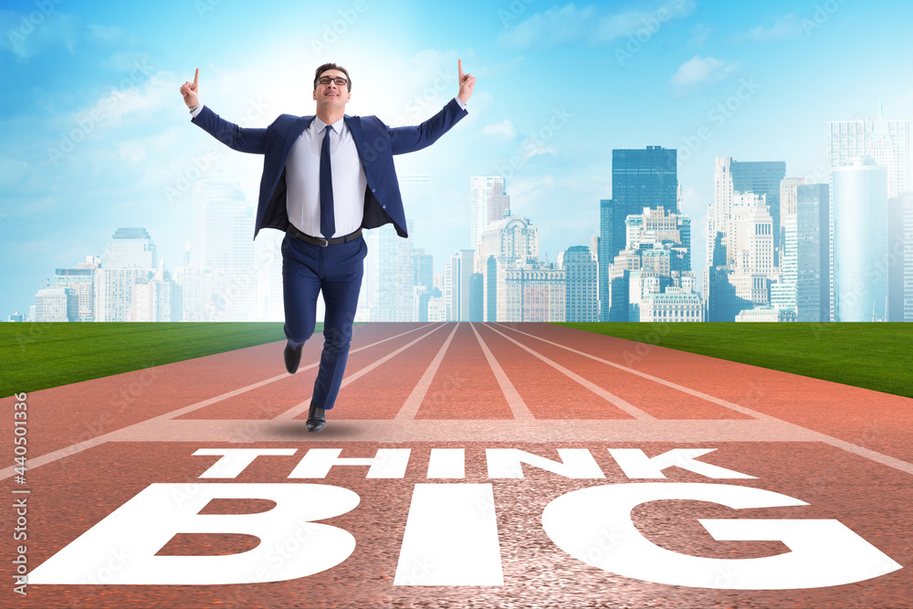 Businessman in think big concept on running track Businessman in think big concept on running track