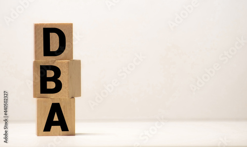 DBA - acronym from wooden blocks with letters, DataBase Administrator or doing business as abbreviation DBA concept photo