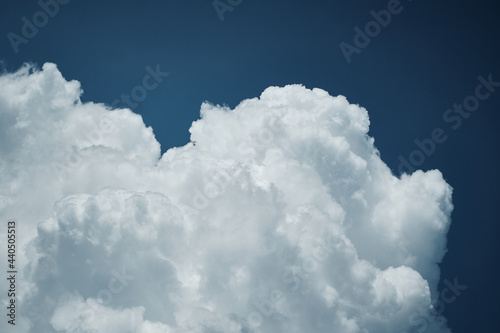 White cloud formation over deep blue sky