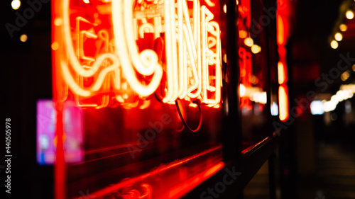 Color Neon Sign Glowing At Night Behind Glass