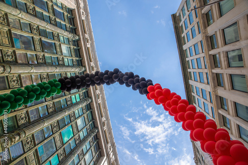 Red-Black-Green flag from balloons on a blue sky background. Black Liberation African American Flag. Pan-African flag.  Juneteenth National Independence Day. Copy space for your text