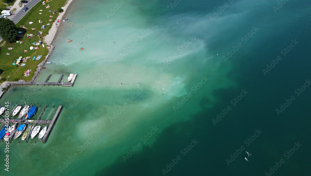 Luftaufnahme mit einer Drohne vom Plansee mit Wasserverfärbungen, die durch die Badegäste entstanden sind