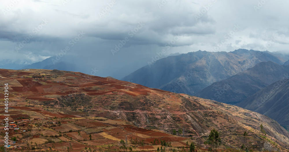 Sacred Valley of the Inca in the Andes mountains with thunder clouds and rain, Cusco, Peru.