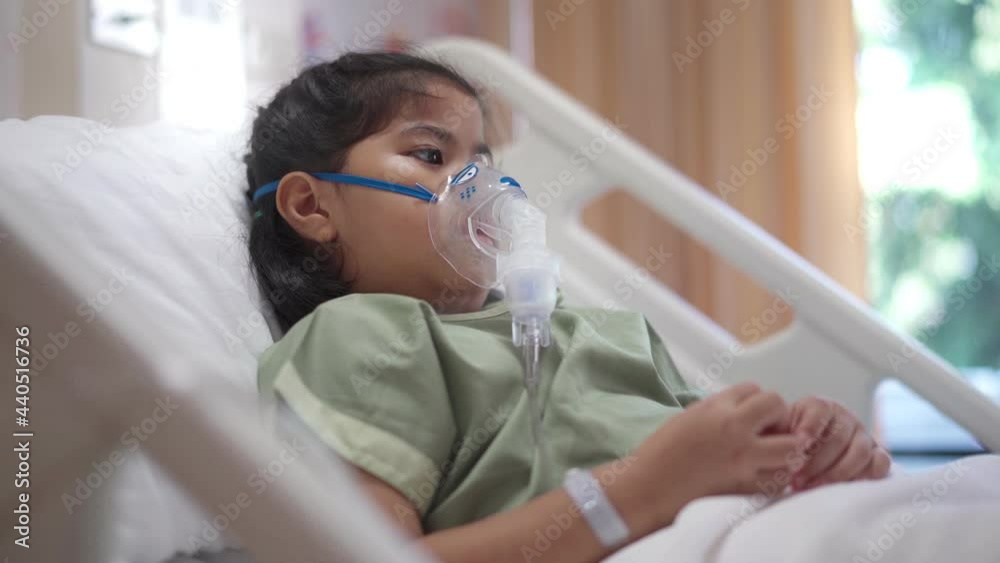 Asian girl 7 year old in hospital using inhaler containing medicine, RSV, Respiratory Syncytial Virus
