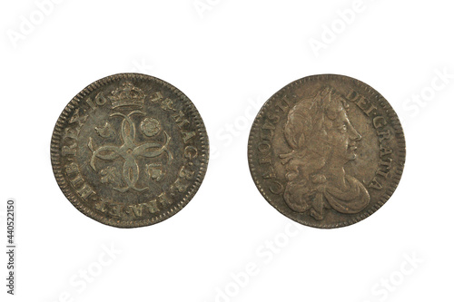 An English King Charles II fourpence coin from 1674. Both sides are shown, isolated on white photo