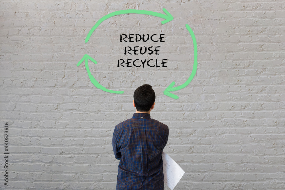 Man staring at wall looking at abstract design with reduce, reuse ...