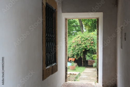 A barred window near the exit to the garden of a house in the colonial town of Olinda, Brazil.