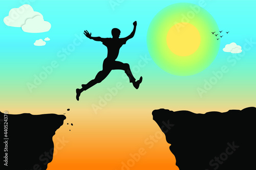 Silhouette of a person jumping at sunset. Man jumping between two mountains.