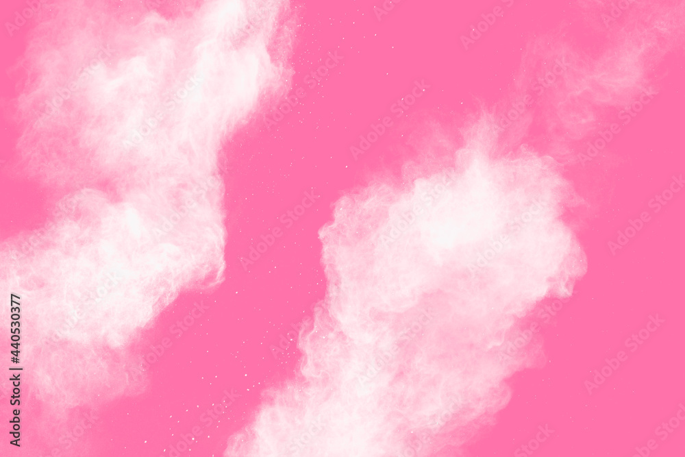 Freeze motion of white powder on pink background. Abstract white dust explosion.