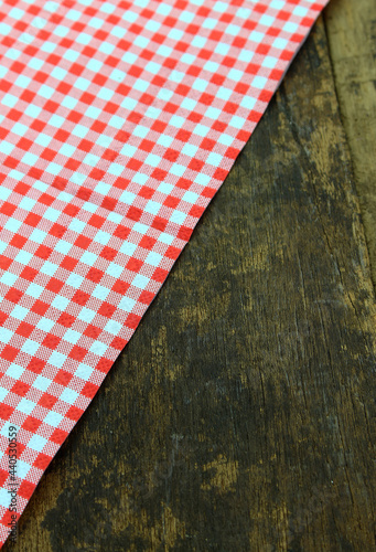 Rustic wooden boards with a red checkered tablecloth