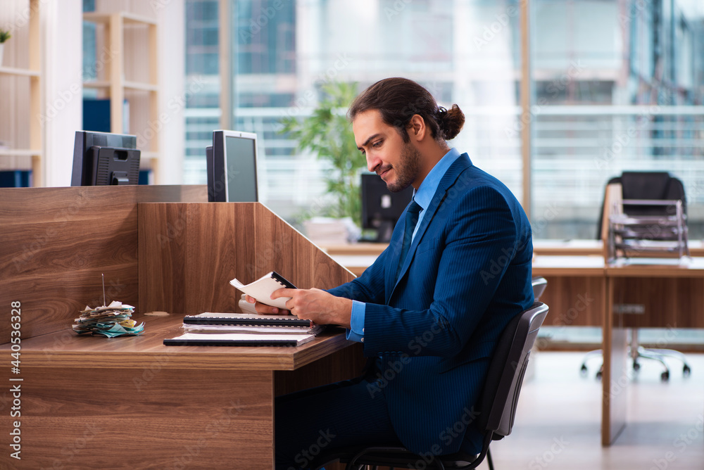 Young male employee working in the office Young male employee working in the office