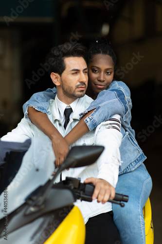 Modeling portrait photo. African American female employee worker and hispanic man manager working together at old auto and car parts warehouse store.