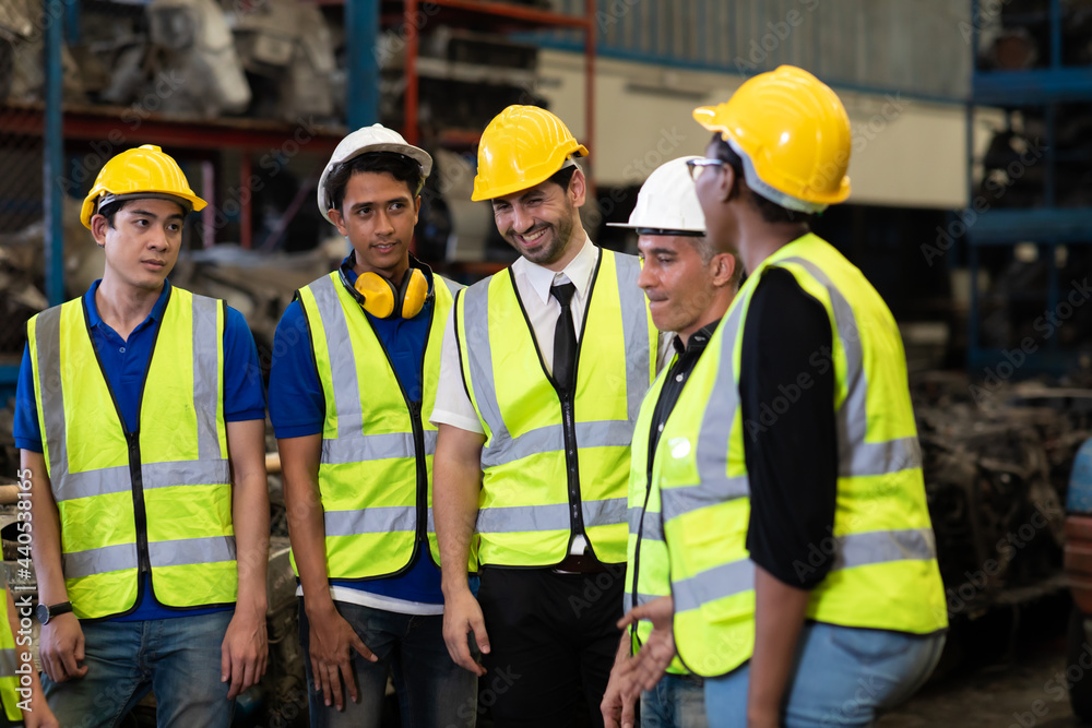 Unity and teamwork concept. team standing hands together. Professional Mechanical Engineer team Working at Second-hand spare parts of old car parts warehouse store. High five. Unity and teamwork concept. team standing hands together. Professional Mechanical Engineer team Working at Second-hand spare parts of old car parts warehouse store. High five.