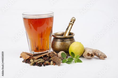 Old bronze pounder and herbal tea with ingredients isolated on white background